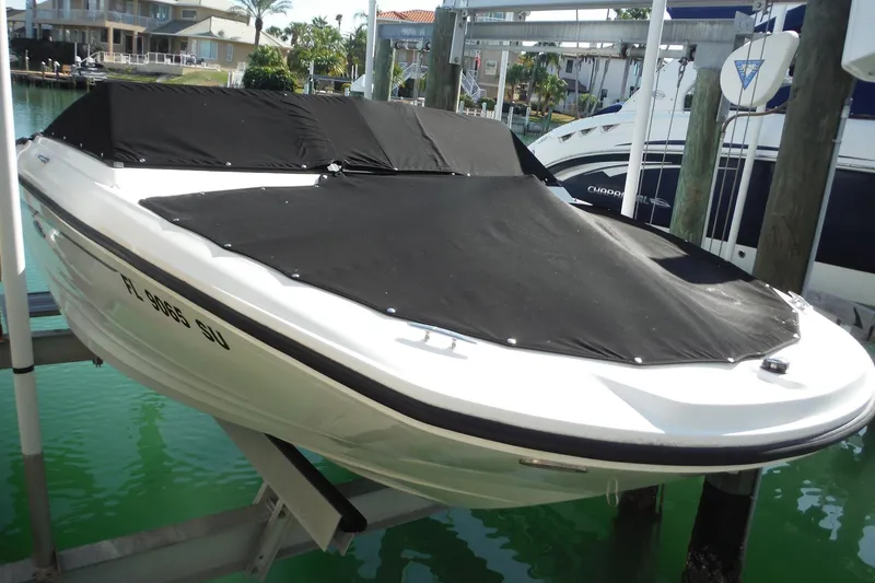 Slide: The Image of 2021 Sea Ray SPX 190 Outboard boat with black cover docked in marina. - 40