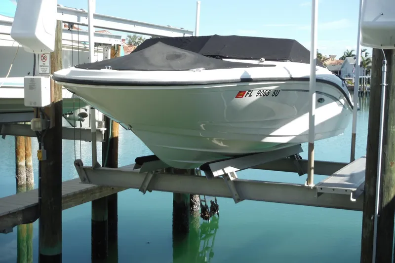 Slide: The Image of 2021 Sea Ray SPX 190 Outboard boat on lift, covered, docked in marina. - 42