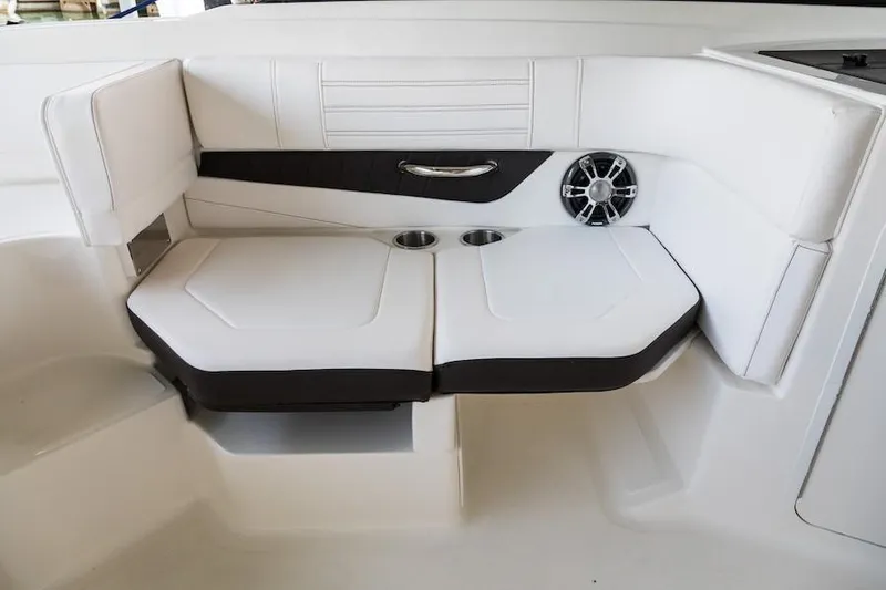 Slide: The Image of Manufacturer Provided Image: 2021 Sea Ray SPX 190 OB boat interior seating with cup holders and speaker. - 8
