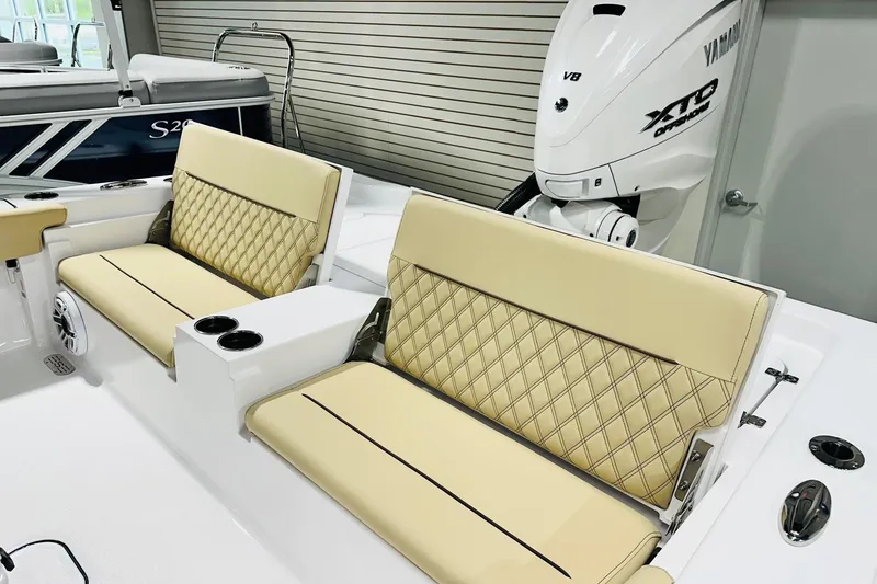 Slide: The Image of 2026 Sportsman Masters 267 Bay Boat interior with beige diamond-stitched seating and Yamaha V8 engine. - 11