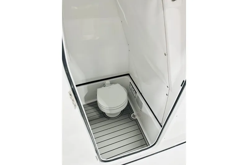 Slide: The Image of 2026 Sportsman Masters 267 Bay Boat interior with compact marine toilet. - 12