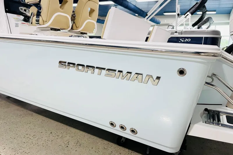Slide: The Image of 2026 Sportsman Masters 267 Bay Boat, sleek design with comfortable seating, showcased indoors. - 14