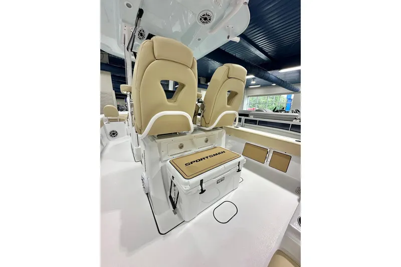 Slide: The Image of 2026 Sportsman Masters 267 Bay Boat interior with beige seating and storage. - 4