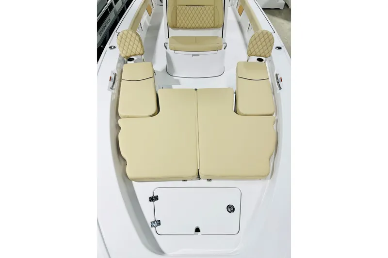 Slide: The Image of 2026 Sportsman Masters 267 Bay Boat interior with beige cushioned seating. - 7
