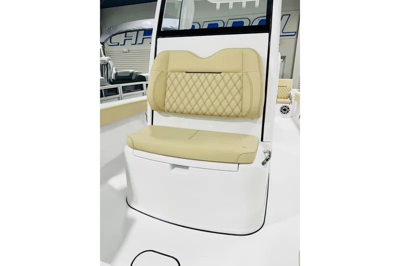 Slide: The Image of 2026 Sportsman Masters 267 Bay Boat with beige cushioned seating and diamond stitching. - 8