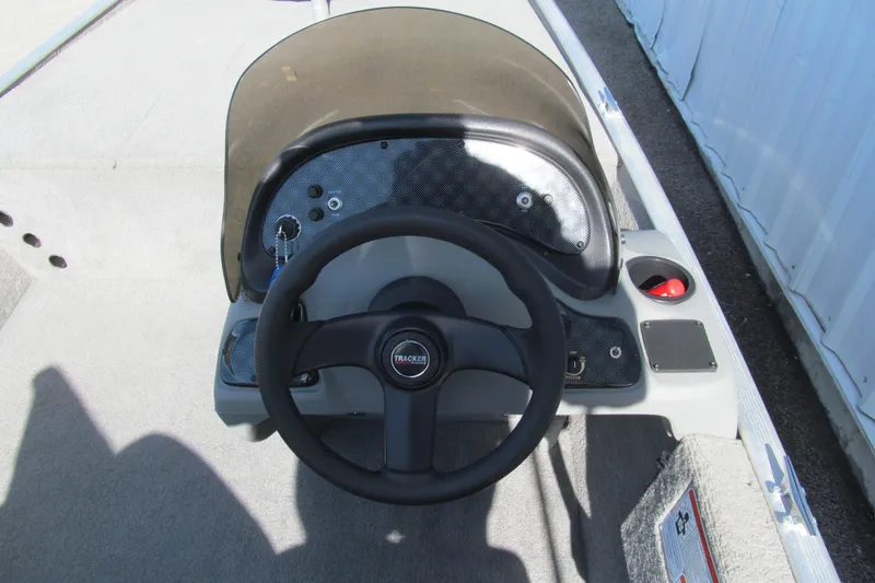 Slide: The Image of Steering console of a 2010 Tracker Pro 16 boat with a black wheel. - 5