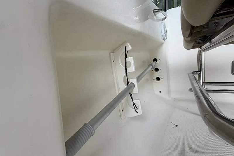 Slide: The Image of Interior view of a 2007 Scout 222 Dorado boat, featuring rod holders and seating. - 22