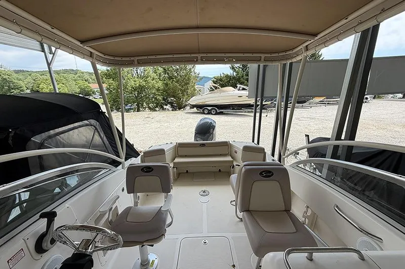 Slide: The Image of Interior view of a 2007 Scout 222 Dorado boat with seating and canopy. - 26
