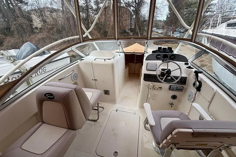 Slide: The Image of 2007 Scout 222 Dorado boat interior with steering wheel and seating. - 9