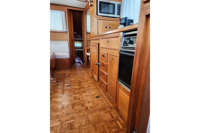 Slide: The Image of Interior of 1996 Grand Banks 36 Sedan with wood cabinetry and parquet flooring. - 11
