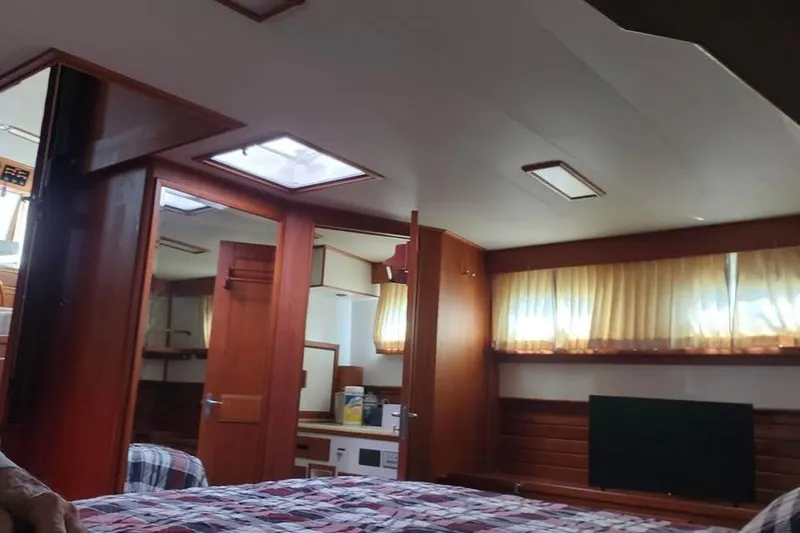 Slide: The Image of Interior of 1996 Grand Banks 36 Sedan with wood paneling and cozy furnishings. - 12