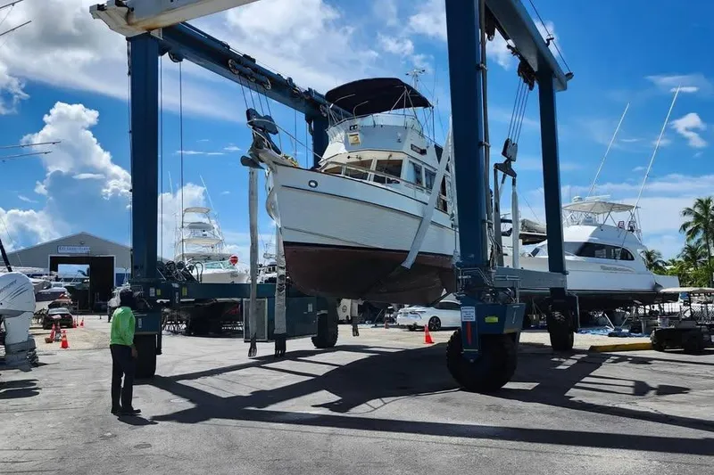 Slide: The Image of 1996 Grand Banks 36 Motoryacht docked, featuring upper deck and cabin windows. - 2