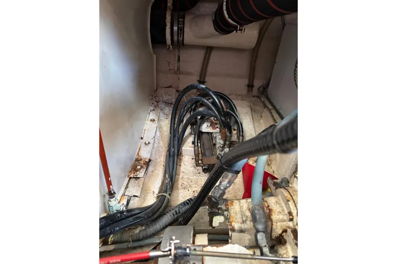 Slide: The Image of Engine compartment of 1996 Grand Banks 36 Motoryacht with visible cables and hoses. - 31