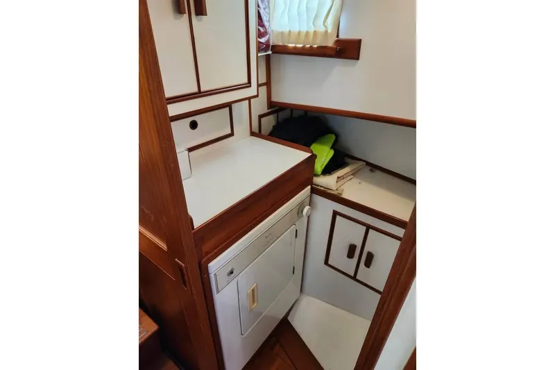 Slide: The Image of 1996 Grand Banks 36 Motoryacht docked, showcasing deck and marina view. - 5