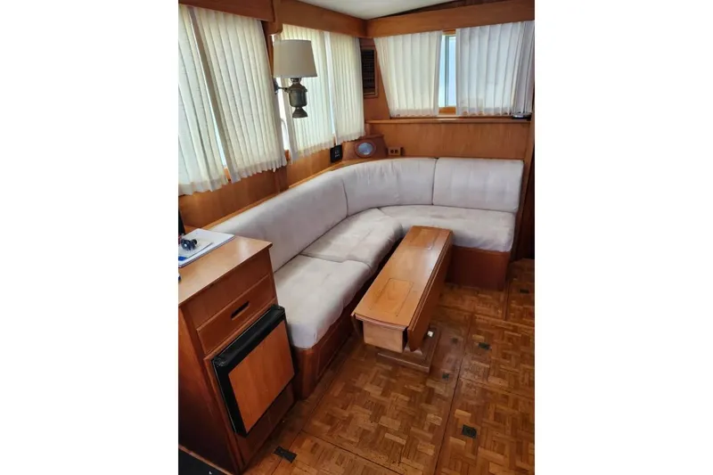 Slide: The Image of 1996 Grand Banks 36 Sedan interior with wood cabinetry and compact storage space. - 9