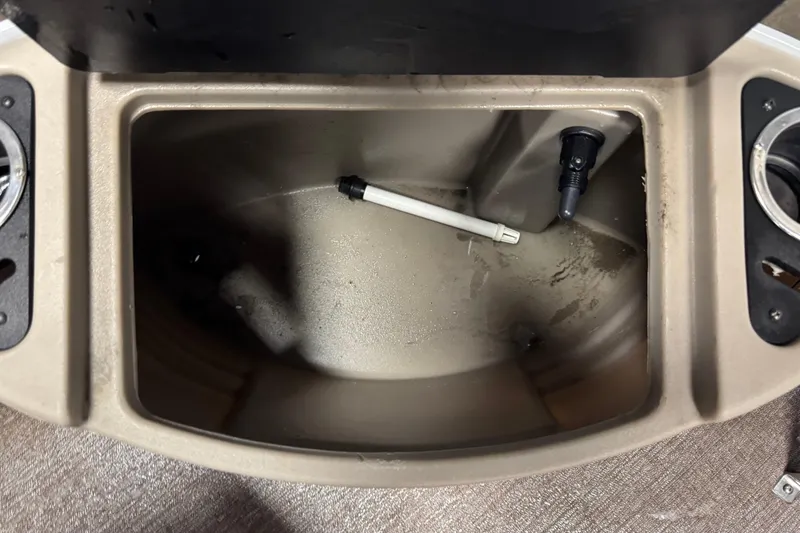Slide: The Image of 2020 Ranger Reata 220F boat compartment with cup holders and drainage pipe. - 11