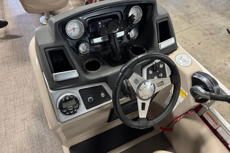 Slide: The Image of 2020 Ranger Reata 220F boat dashboard with steering wheel and control panel. - 13