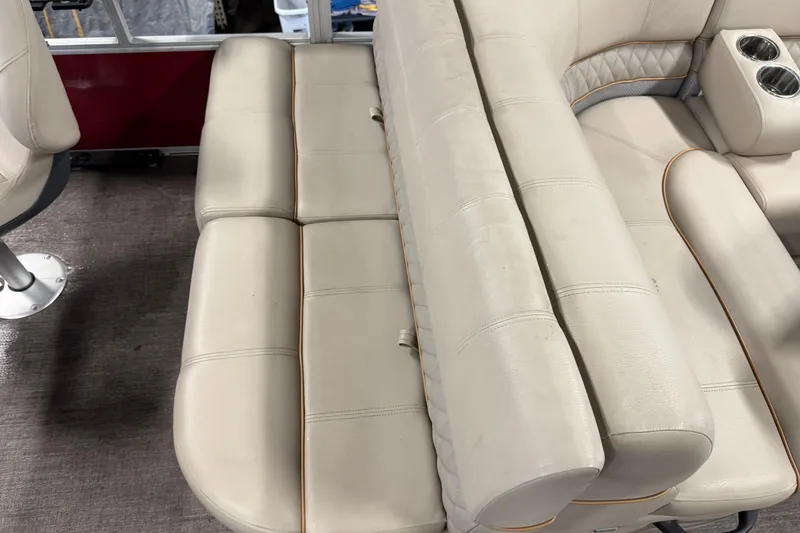 Slide: The Image of 2020 Ranger Reata 220F boat interior with beige cushioned seating and cup holders. - 16