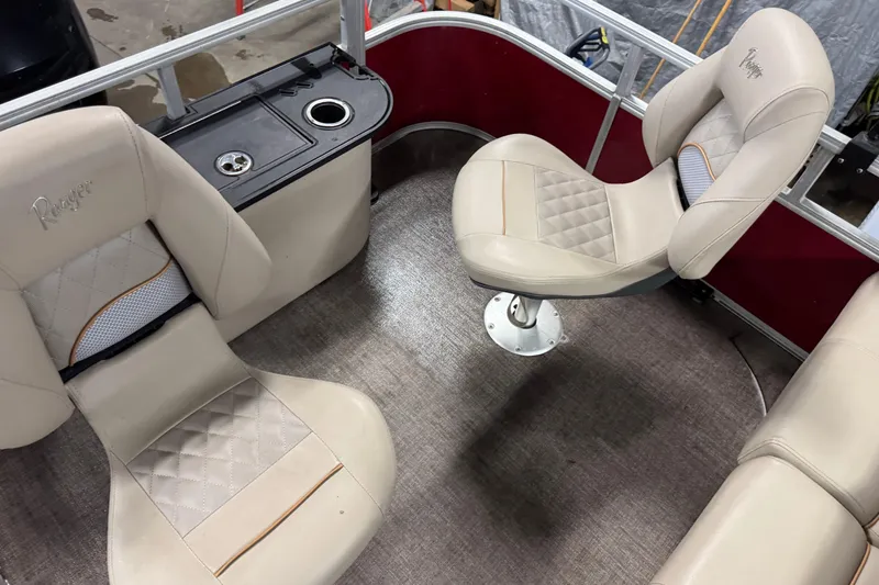 Slide: The Image of 2020 Ranger Reata 220F boat interior with beige seats and cup holders. - 18