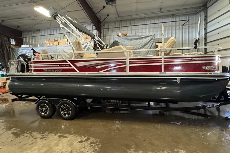Slide: The Image of 2020 Ranger Reata 220F pontoon boat in a warehouse setting. - 3