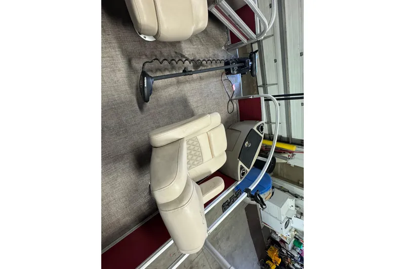 Slide: The Image of 2020 Ranger Reata 220F boat interior with beige seating and steering console. - 6