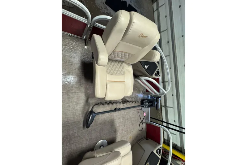 Slide: The Image of 2020 Ranger Reata 220F boat interior with beige captain's chair and steering console. - 7