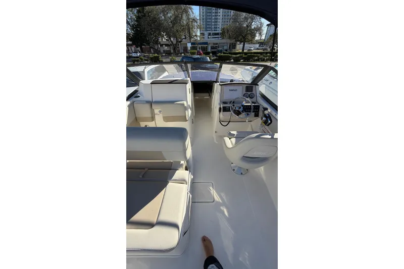 Slide: The Image of 2024 Boston Whaler 210 Vantage boat interior with seating and helm controls. - 10