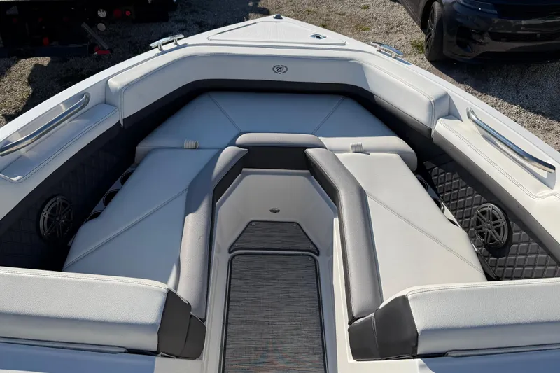 Slide: The Image of 2024 Boston Whaler 210 Vantage boat interior with cushioned seating and speakers. - 12