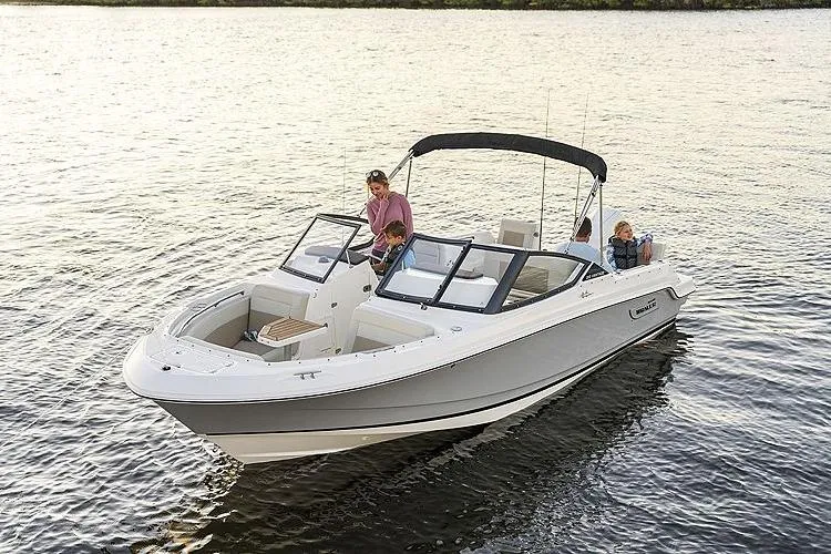 Slide: The Image of 2024 Boston Whaler 210 Vantage boat cruising on calm water with passengers. - 16