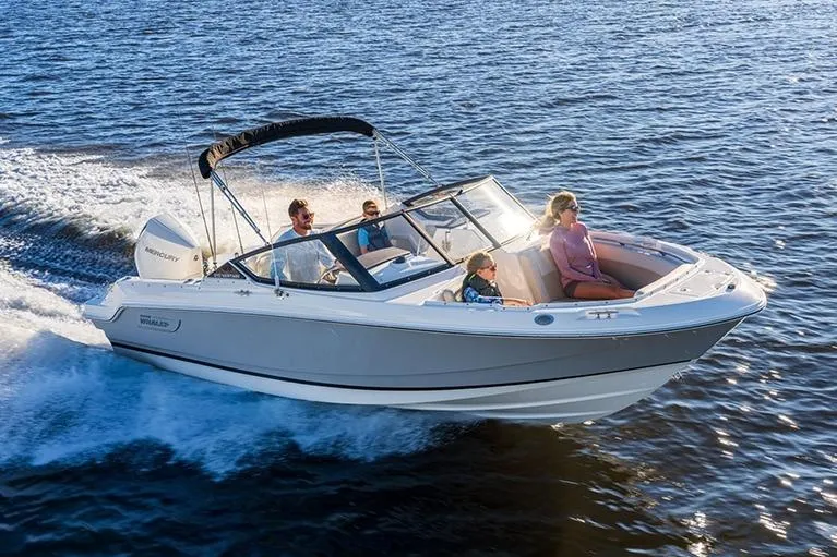 Slide: The Image of 2024 Boston Whaler 210 Vantage cruising on open water with passengers. - 19