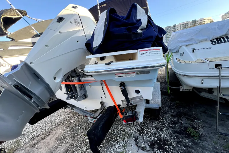Slide: The Image of 2024 Boston Whaler 210 Vantage boat, rear view with motor, on a trailer. - 28