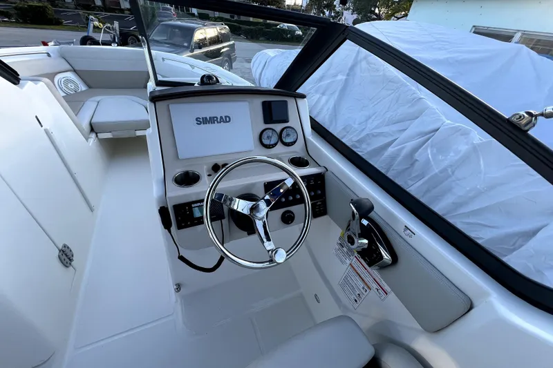 Slide: The Image of 2024 Boston Whaler 210 Vantage boat cockpit with Simrad navigation system and steering wheel. - 29