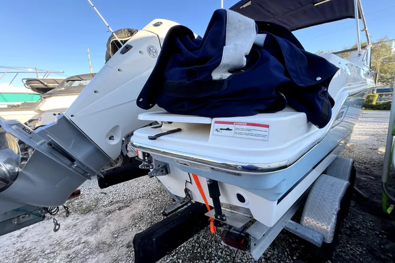 Slide: The Image of 2024 Boston Whaler 210 Vantage boat on trailer, rear view with outboard motor. - 30