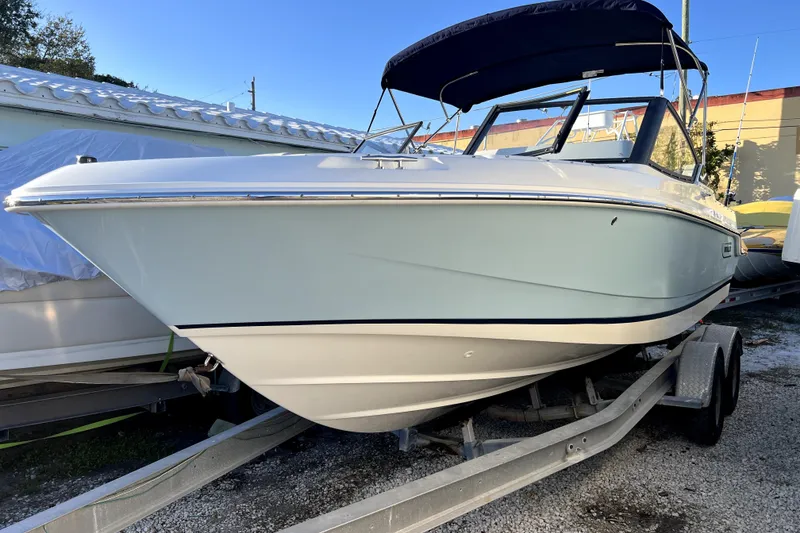 Slide: The Image of 2024 Boston Whaler 210 Vantage boat on trailer, side view, sunny day. - 31