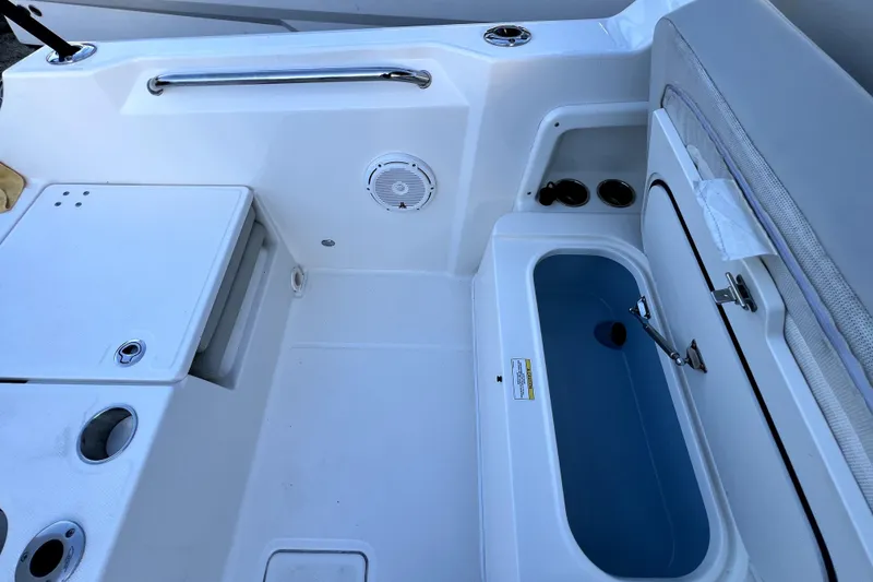 Slide: The Image of 2024 Boston Whaler 210 Vantage boat interior with storage compartments and seating. - 36