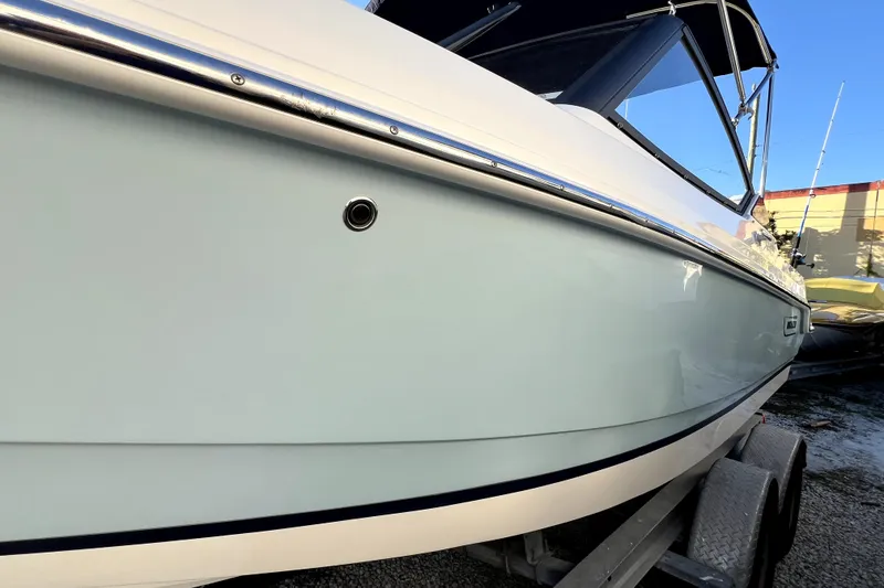 Slide: The Image of 2024 Boston Whaler 210 Vantage boat side view on trailer. - 38