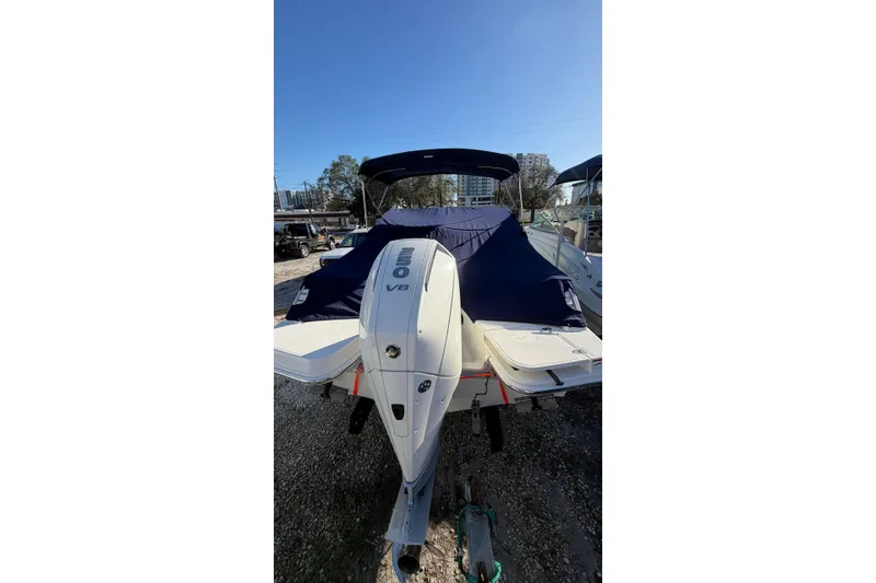 Slide: The Image of 2024 Boston Whaler 210 Vantage boat with covered seating and powerful V8 engine. - 4