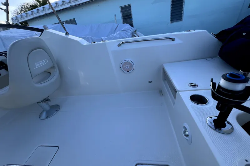 Slide: The Image of 2024 Boston Whaler 210 Vantage boat interior with seating and fishing rod holder. - 40