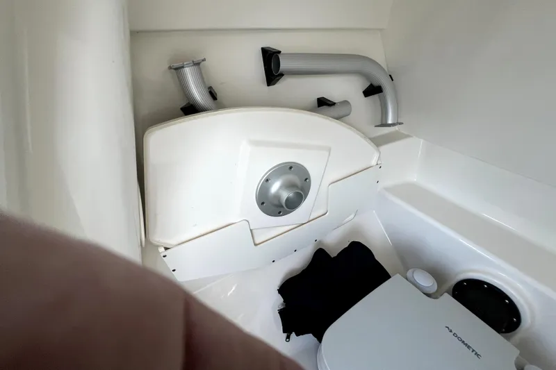Slide: The Image of 2024 Boston Whaler 210 Vantage interior with Dometic marine toilet and storage area. - 41