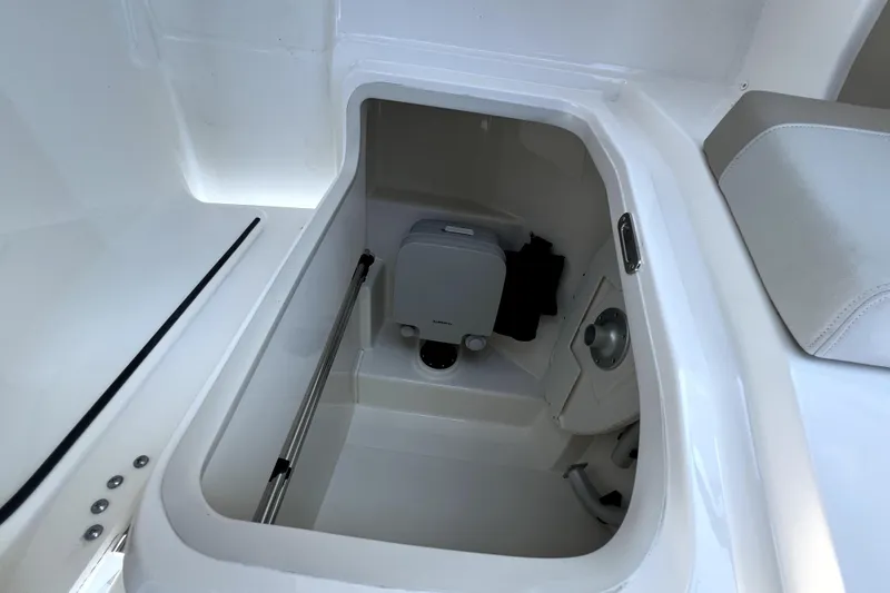 Slide: The Image of 2024 Boston Whaler 210 Vantage boat interior storage compartment with white finish. - 42