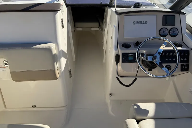 Slide: The Image of 2024 Boston Whaler 210 Vantage boat interior with steering wheel and control panel. - 5