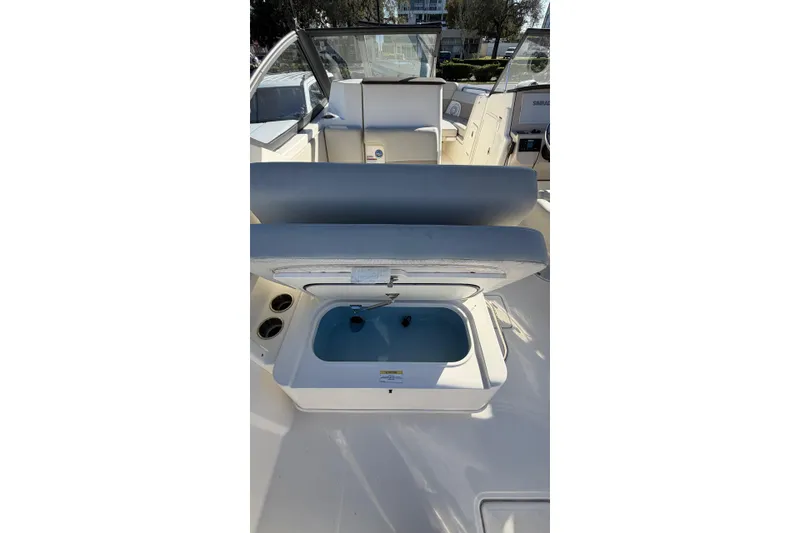 Slide: The Image of 2024 Boston Whaler 210 Vantage boat interior with open storage compartment. - 8