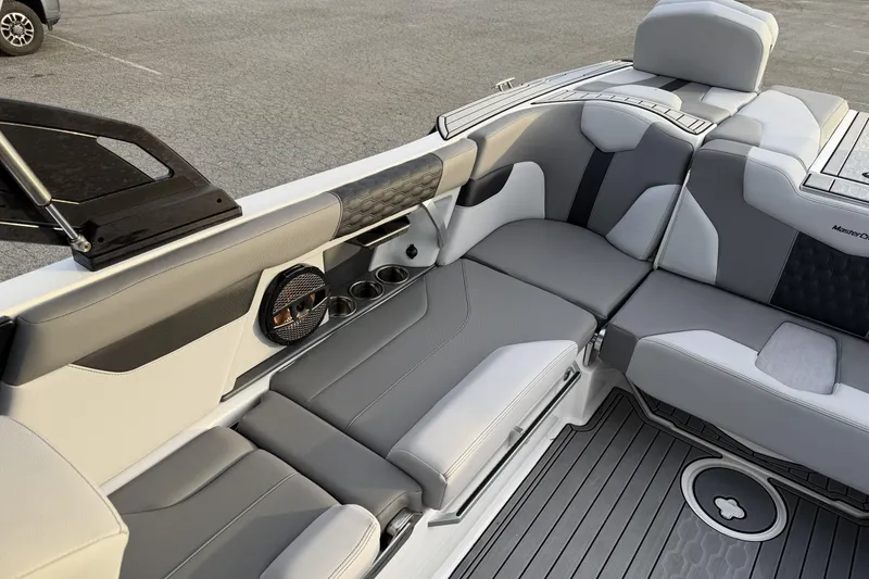 Slide: The Image of 2023 MasterCraft XT24 boat interior with gray seating and cup holders. - 10