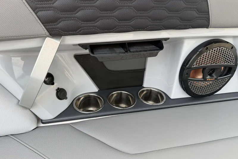 Slide: The Image of 2023 MasterCraft XT24 interior with cup holders and speaker system. - 15