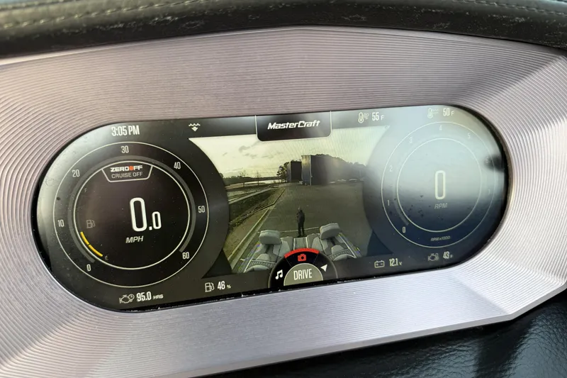 Slide: The Image of 2023 MasterCraft XT24 dashboard display showing speed, RPM, and rear camera view. - 17