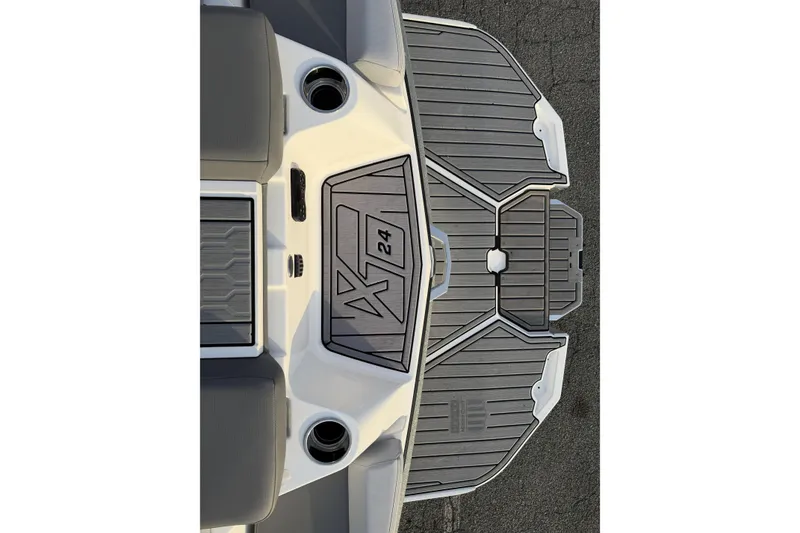 Slide: The Image of 2023 MasterCraft XT24 boat deck with sleek gray design and cup holders. - 20