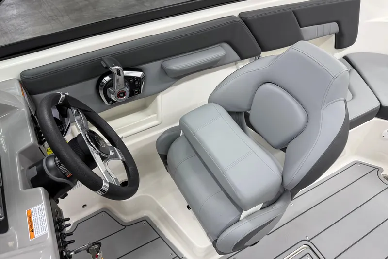 Slide: The Image of 2026 Chaparral 23 SSi boat interior with steering wheel and gray seating. - 10