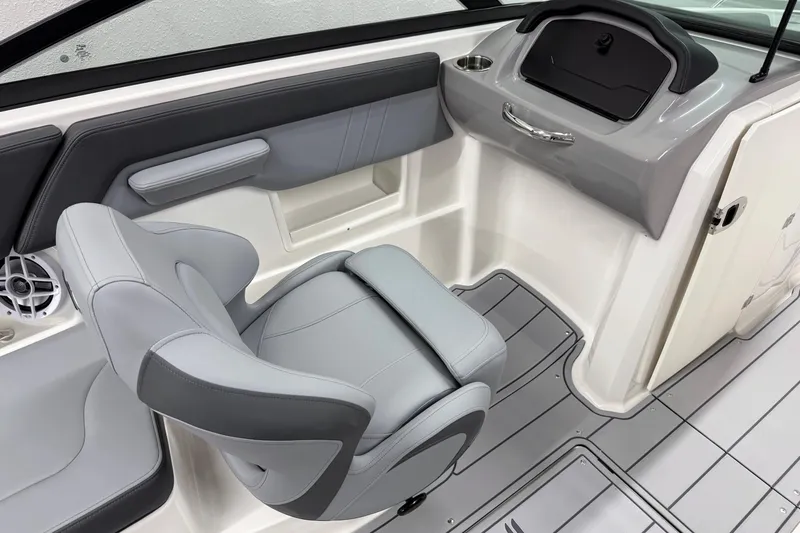 Slide: The Image of 2026 Chaparral 23 SSi boat interior with gray seating and modern dashboard design. - 14