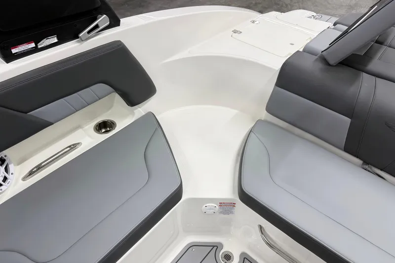 Slide: The Image of Interior seating of 2026 Chaparral 23 SSi boat, featuring gray upholstery and cup holder. - 18