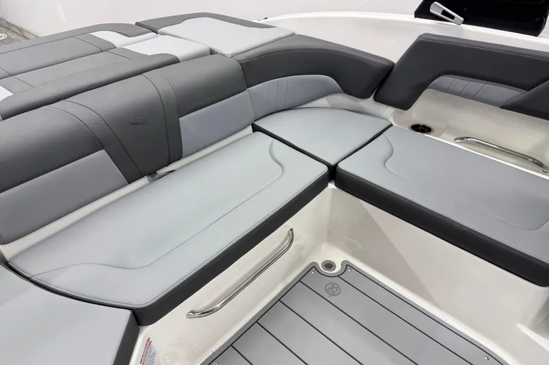 Slide: The Image of 2026 Chaparral 23 SSi boat interior with sleek gray seating and modern design. - 19